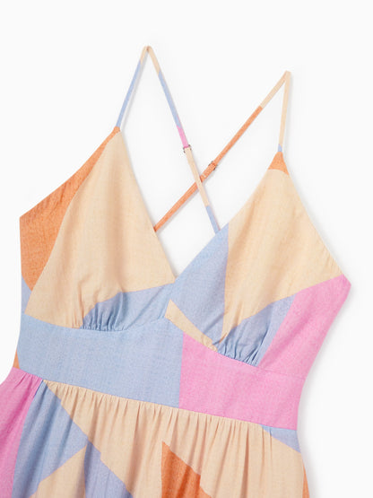 Colorful geometric-patterned dress on a white background