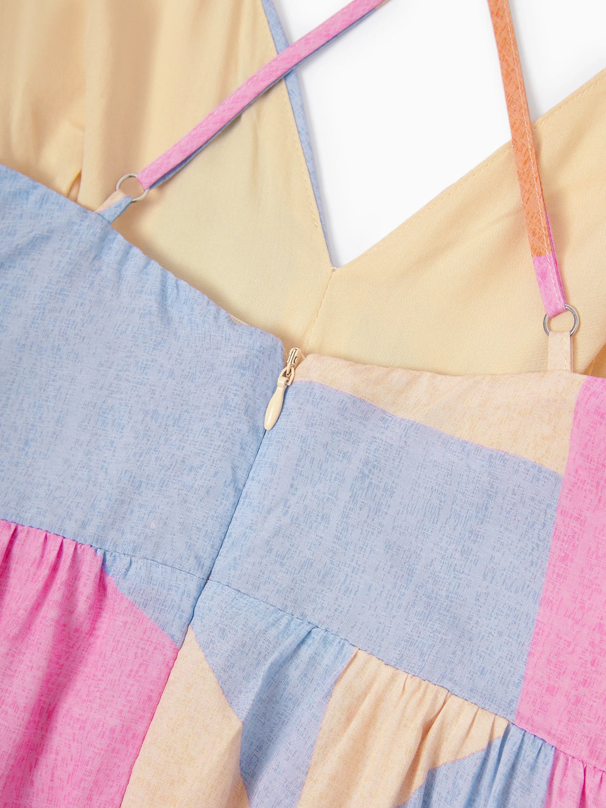 Color-blocked dress with pink, blue, and yellow straps on a white background